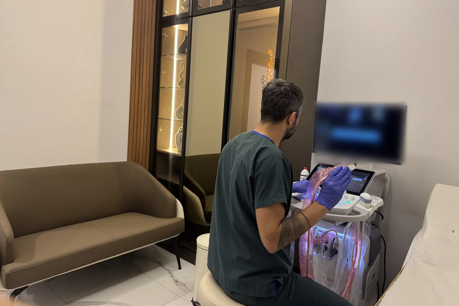 Op. Dr. Hüseyin Efe Akalın at the ultrasound machine in the examination room