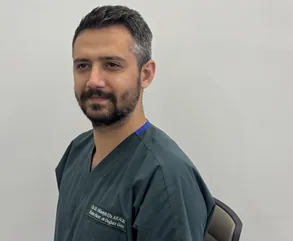 Op. Dr. Hüseyin Efe Akalın, close-up portrait in surgical scrubs