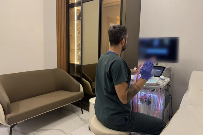 Op. Dr. Hüseyin Efe Akalın adjusting the ultrasound machine