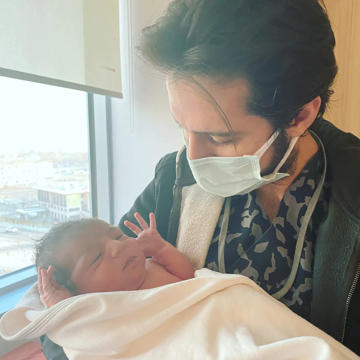 Op. Dr. Hüseyin Efe Akalın holding a newborn baby